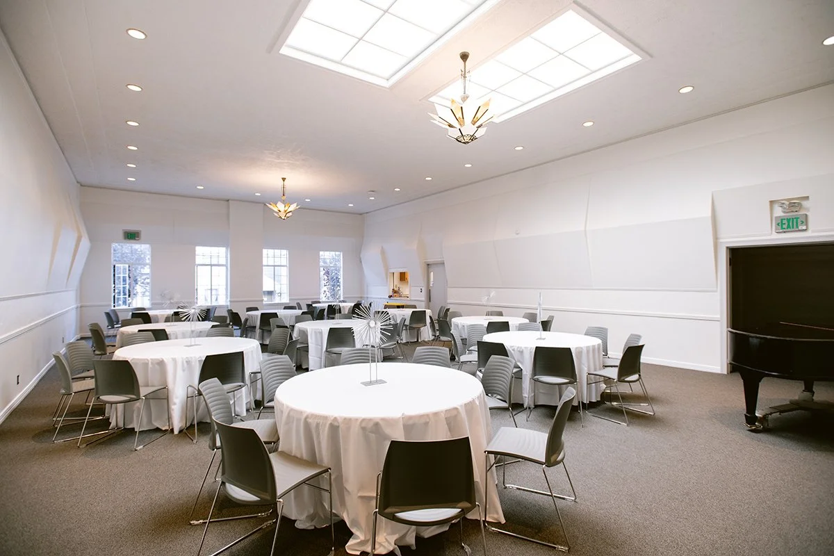 Elgin Park Room arranged with round tables and chairs beside a grand piano